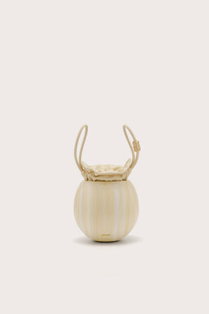 A spherical handbag made of marbles yellow acrylic with an inner pouch that sinches closed and two matching handles. 