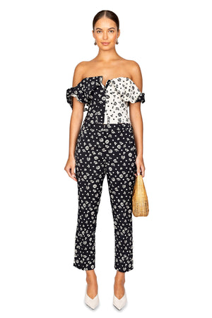 Model facing front styled in the black with cream floral print pants.