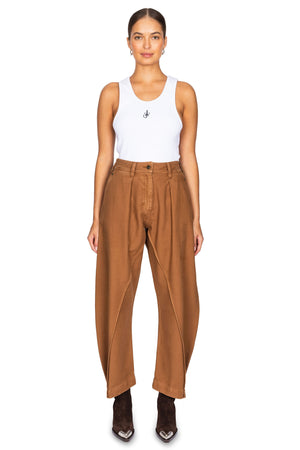 Model wears the wide curve leg brown twisted seam trousers.