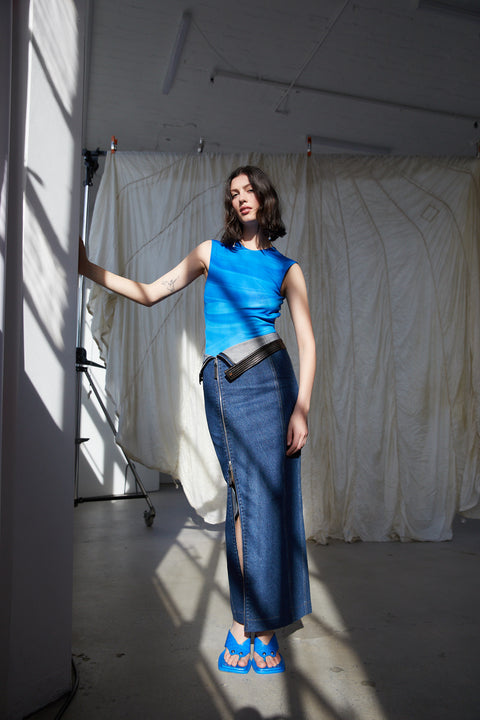 Model styled in the blue circle bodysuit with jean skirt.