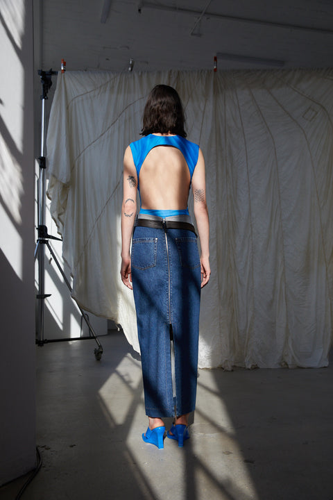 Model facing away showing the open back of the blue circle bodysuit.