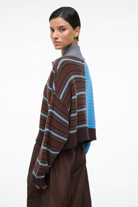 Woman turned a striped sweater with a white background