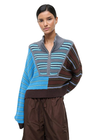 Woman wearing a colorful striped sweater on a white background