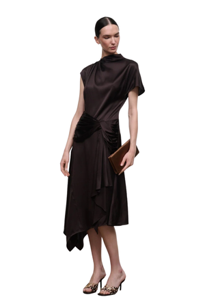 A model wearing a dark brown satin midi dress with a high neck, short sleeves, and a gathered waist, holding a brown clutch against a plain white background.