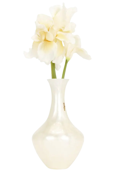 A glossy white ceramic vase clutch bag with a rounded bulbous base, holding two pale cream artificial flowers with green stems, isolated on a white background.