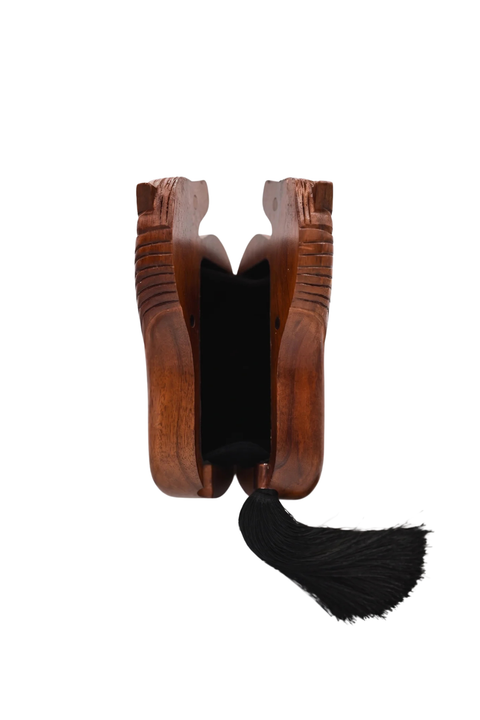 A wooden box with carved details, featuring a black velvet-lined interior and a long black tassel hanging from the bottom center, shown against a plain white background.