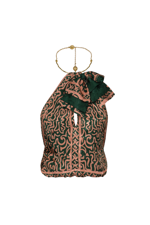 A green and salmon patterned halter top with a cutout and a metal brass neck accent