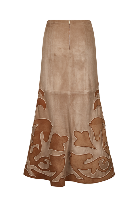 A beige suede-like midi skirt with a brown abstract cutout pattern along the lower half, shown against a plain white background.