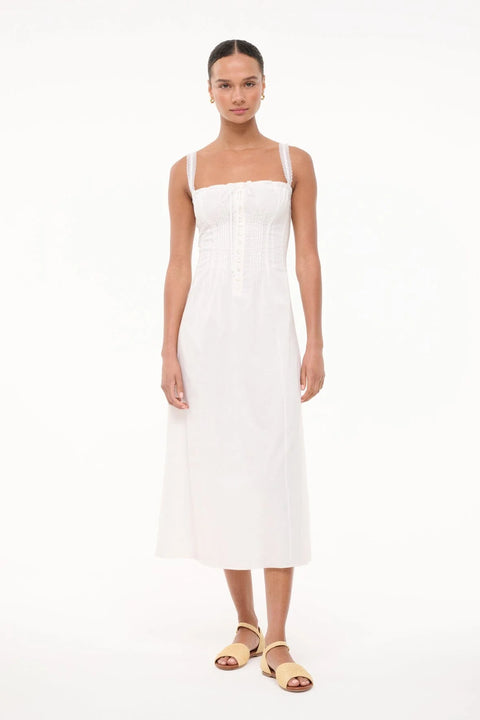 Woman wearing a white dress on a white background