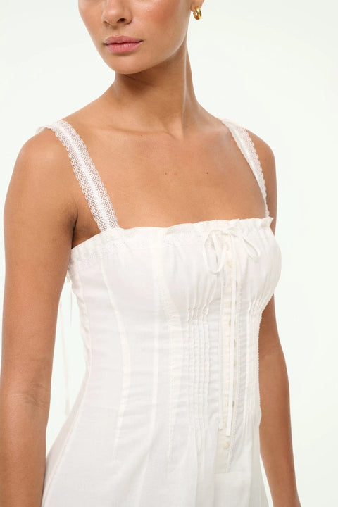 Detail shot of a woman wearing a white midi dress. 