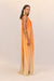 Side angle of a woman wearing an orange ombre maxi dress that features a high neck and ribbons of silk cascading from the bust to the floor.