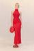 Woman wearing a bright red silk maxi skirt in a flattering bias cut, styles with a red top and red accessories. 