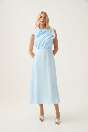 Woman wears light blue midi dress with draped high neckline.