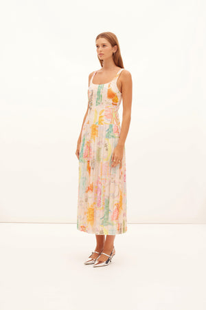 Model facing left in the ethelinda printed pleated midi dress.