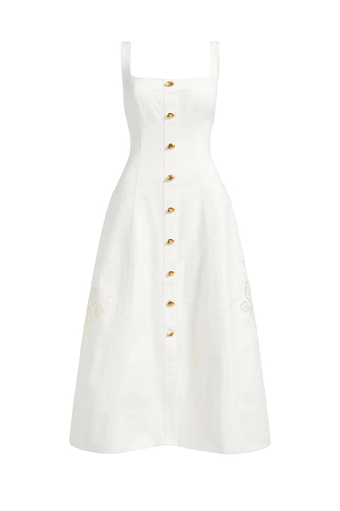 White dress with gold buttons on a light gray background