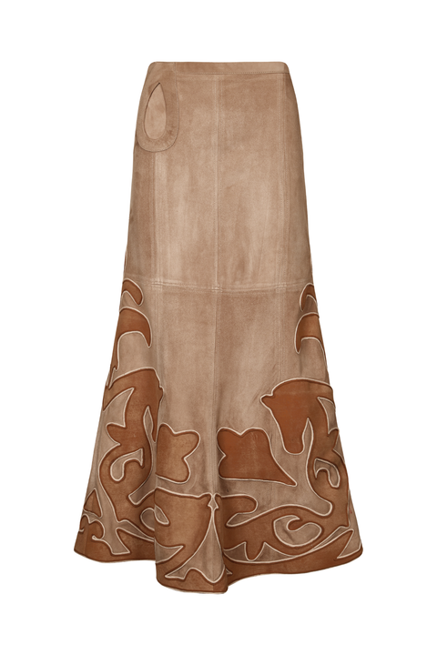 A long beige leather skirt with a brown abstract pattern concentrated along the lower half, shown against a plain white background.