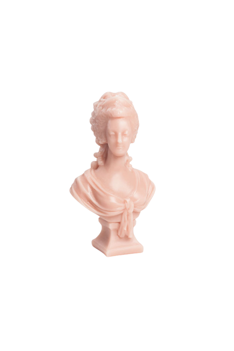A small pale pink wax bust sculpture of marie Antoinette with an ornate updo hairstyle, shown on a plain white background.