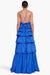 Model facing the back in the bright blue tiered ruffle maxi dress