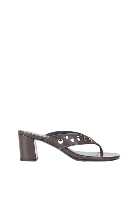 A dark brown leather thong sandal with a chunky block heel and decorative metal eyelets on the strap