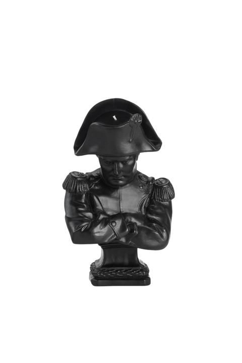 A black wax bust sculpture of Napoleon in a bicorne hat, with arms crossed, set against a plain white background.