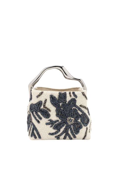 A small structured handbag with a silver-tone metal top handle, featuring a cream-colored beaded body with a dark navy floral pattern, set against a plain white background.