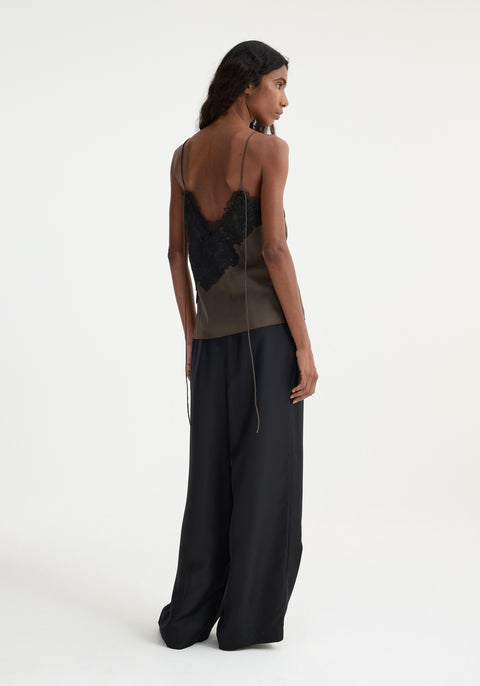 Back of model in lace tank with long strap detail.
