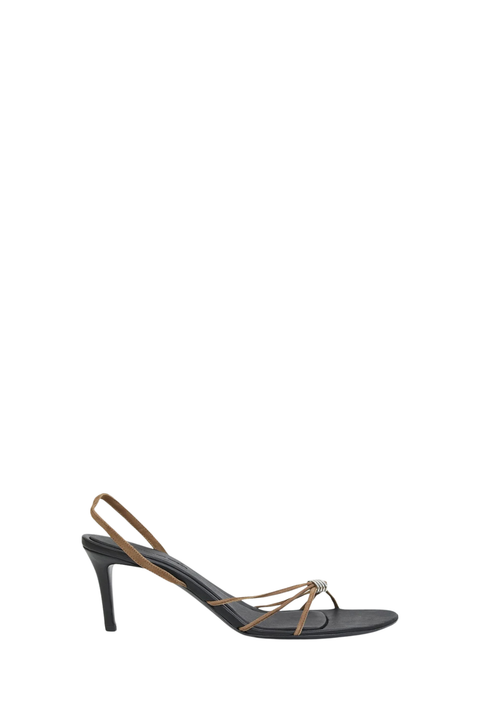A single women's high-heeled sandal shown in side profile on a plain white background. The sandal features a black footbed and heel, with thin metallic gold straps wrapping around the toes and heel.