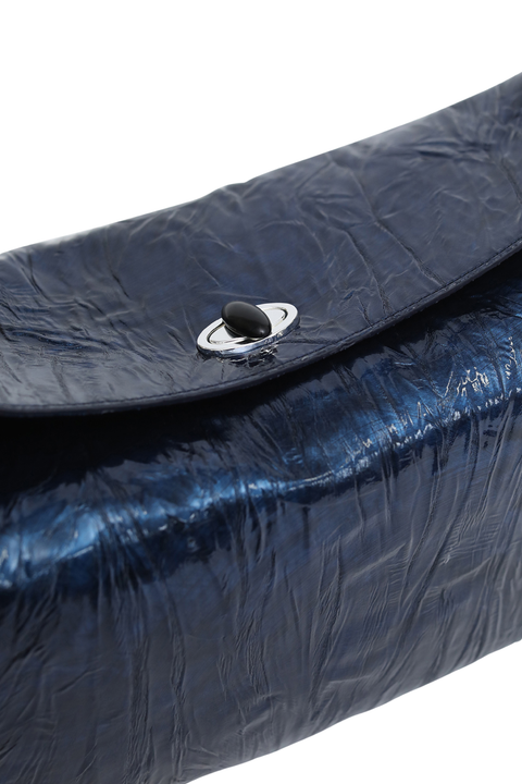 A close-up of a dark blue crinkled leather clutch bag with a silver-toned metal ring clasp on a white background.