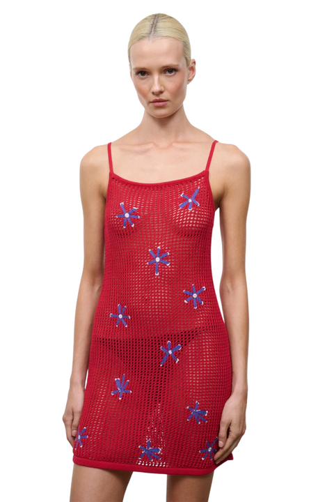 Red dress with floral patterns on a white background close up