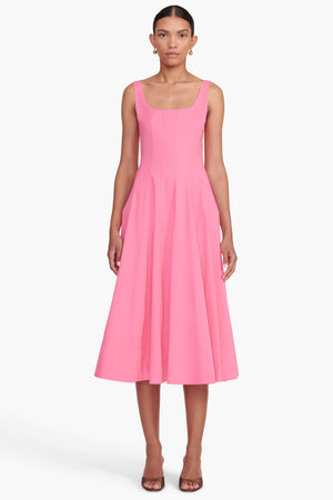 Model facing the camera in a pink sleeveless midi dress