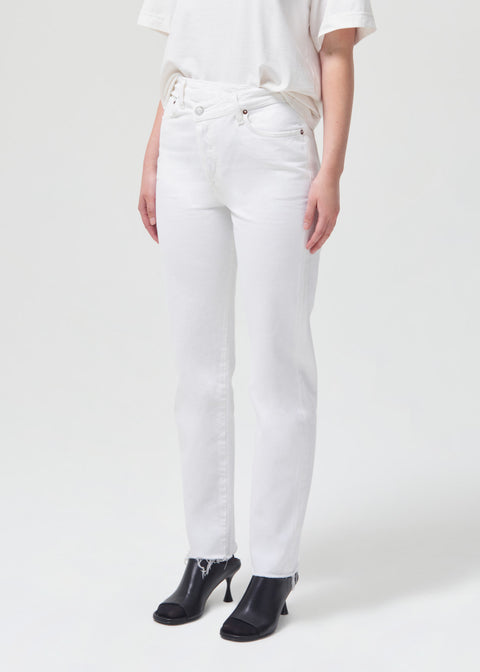 Model facing the left in the criss cross jean.