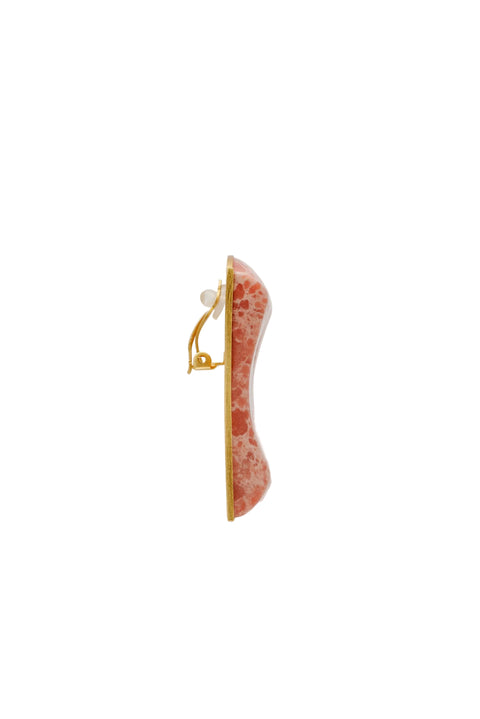 Singular pink faux stone earrings from the side.
