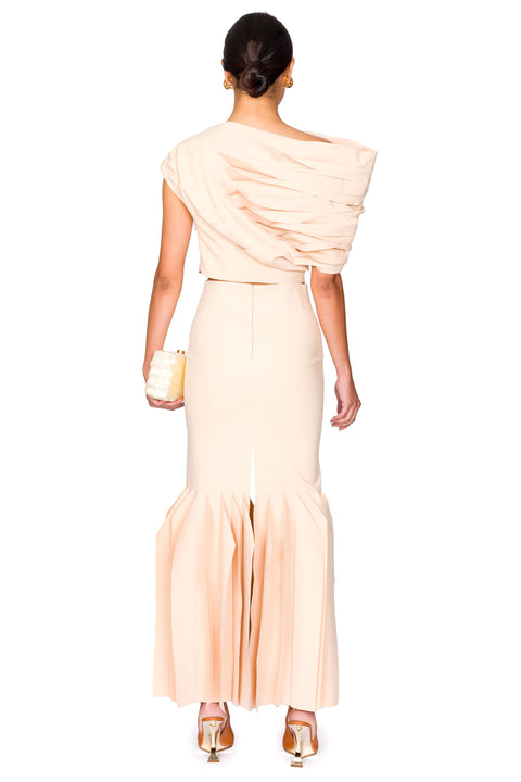 Back of woman wearing matching nude top and maxi skirt.