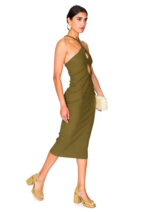 Side view of a woman wearing a green knit midi dress that features a crochet halter neck and two keyhole cutouts at the bust, with crochet rib detailing throughout. 