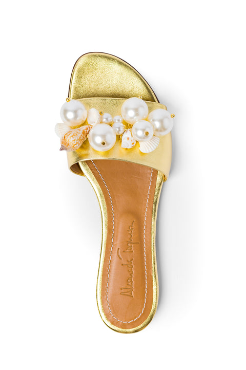 Top view of gold leather slide sandal adorned with faux pearls and seashells.