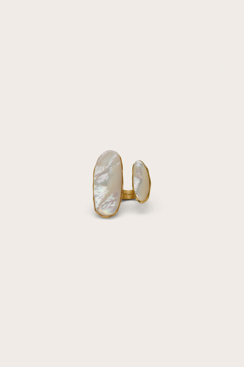Open ended design statement ring that features one small and one larger mother of pearl inlays on each end of the gold ring. 