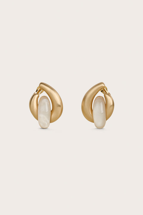 Round, gold statement earrings with an ivory pearlized piece in the center. 