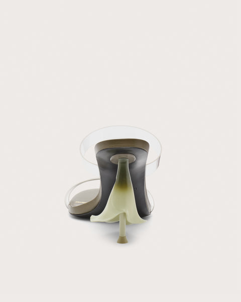 Back profile of a green high heel with clear straps and a calla lily shaped heel. 