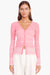 Close up of the pink and white cardigan on a model