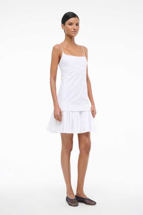 Woman wearing a white dress on a white background