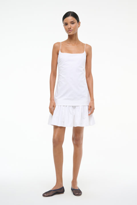 Woman wearing a white dress on a white background
