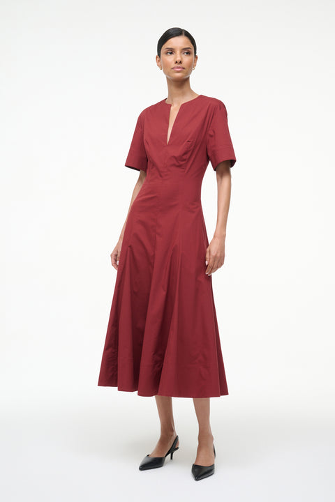 Woman wearing a red dress on a white background