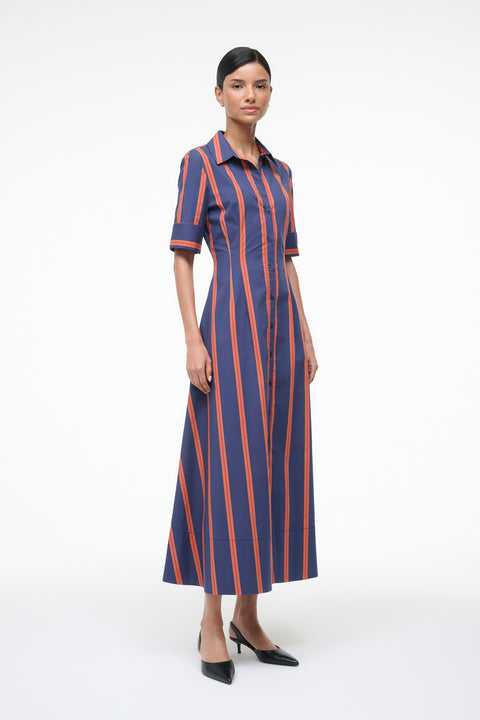 Woman wearing a blue and orange striped dress on a white background