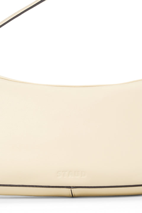 Close up of a cream leather handbag. 