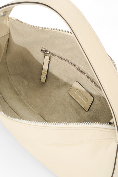 Cream leather handbag with a cream suede lining. 