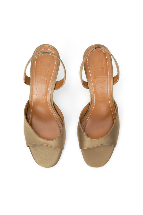 Pair of beige high-heeled sandals on a white background
