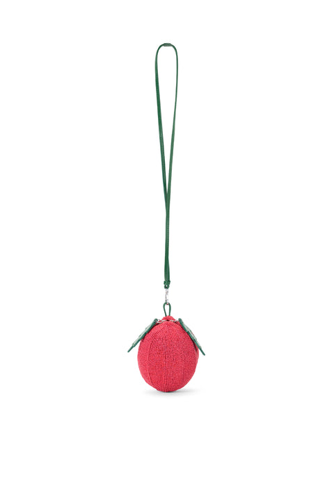 Ghost image of a beaded tomato bag with a green crossbody strap.