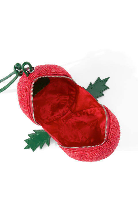 Inside of a red beaded tomato bag with a red lining. 