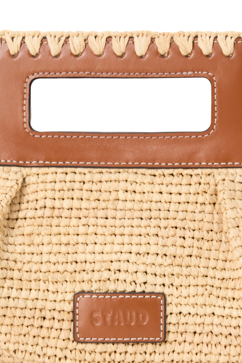 Beige woven handbag with brown leather accents and 'STAUD' branding.
