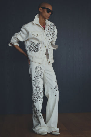 Model wearing the white printed denim oversized jacket with crystal embroidery.